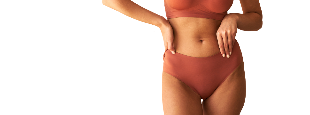 a woman wearing a bikini top and panties.