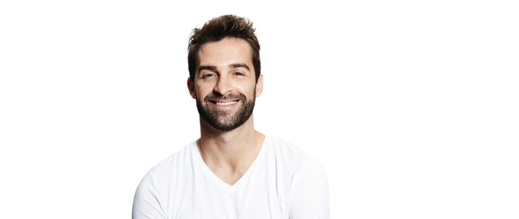 A man with a beard smiling against a black background.