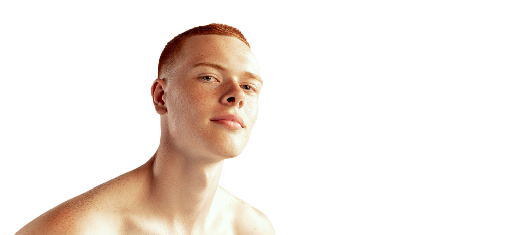 A man with red hair is posing in front of a white background.